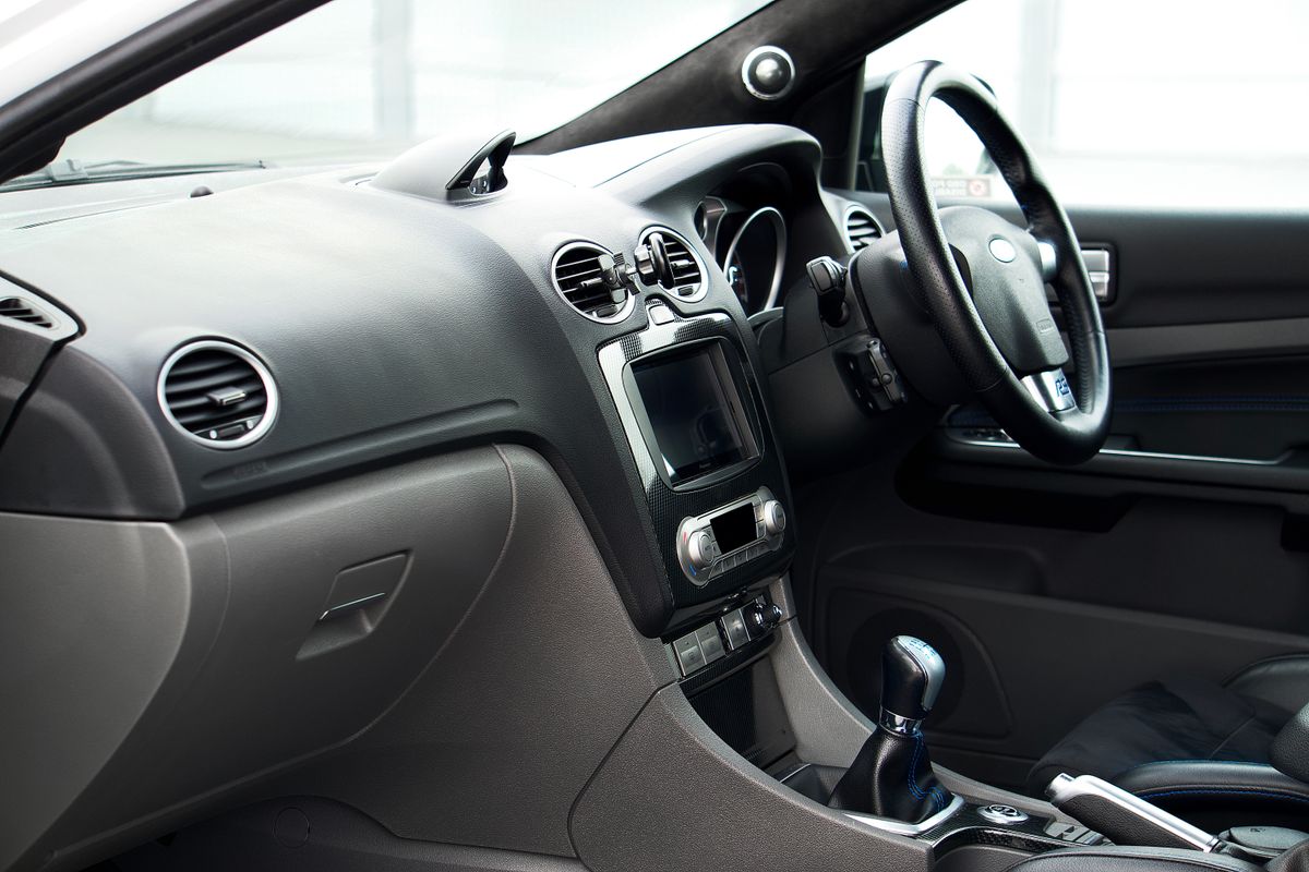 Dashboard and steering wheel of a right-hand-drive UK car used for driving lessons